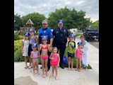 Police officers and a group of kids gathered for National Night Out.